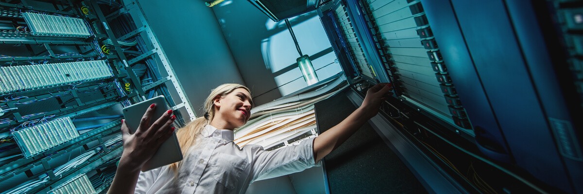Young engineer businesswoman in server room