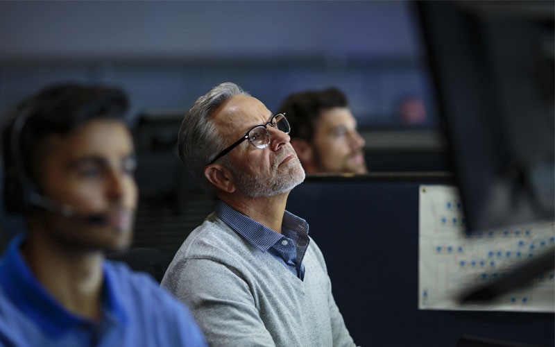Man closely examining data on a computer screen
