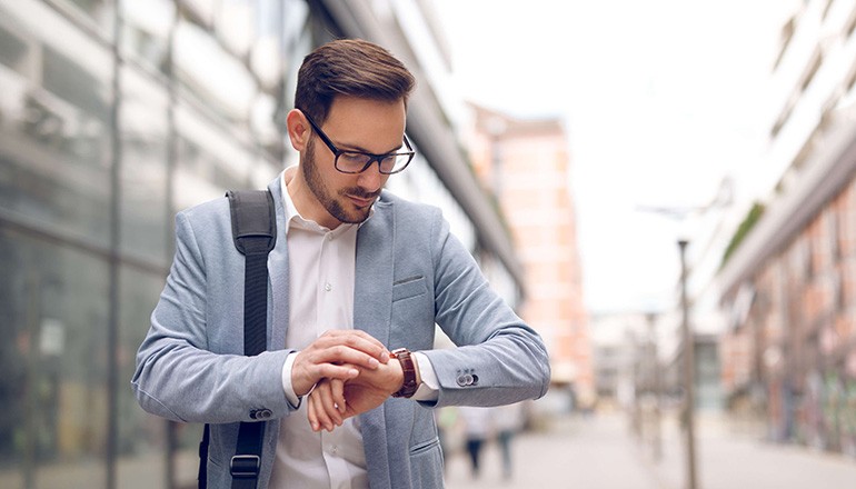 Business man checking messages on his smart watch