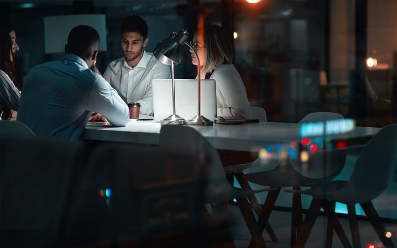 Group of employees working together at night