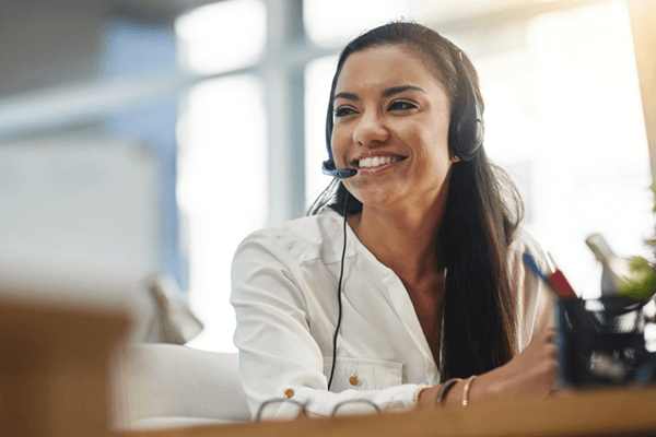 Smiling call center representative ready to help monitor and support your business 
