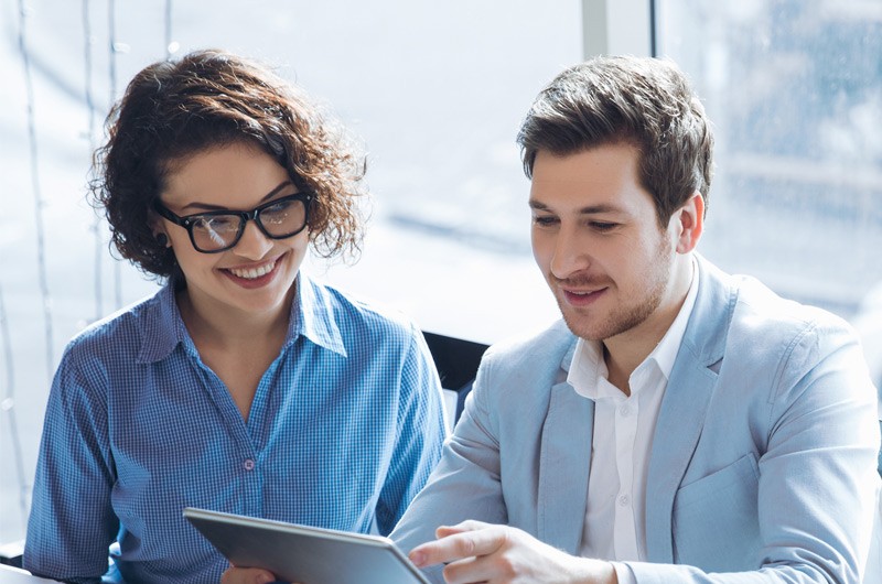 Business professionals discussing project while using tablet computer