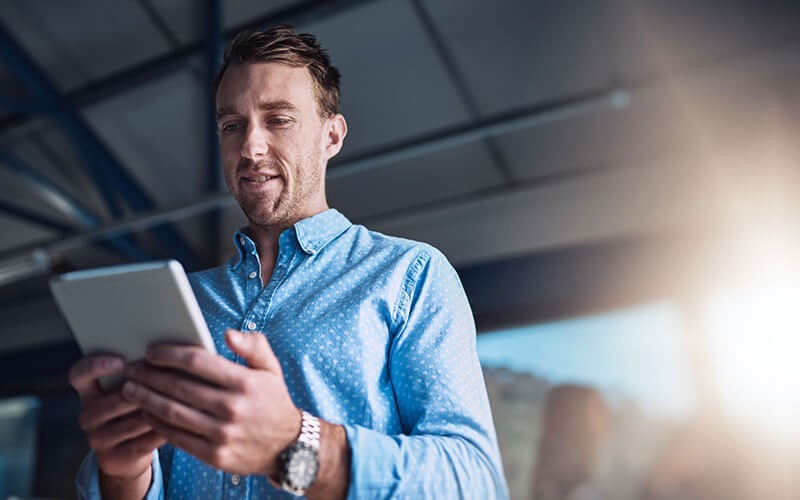 Smiling client using tablet to get data