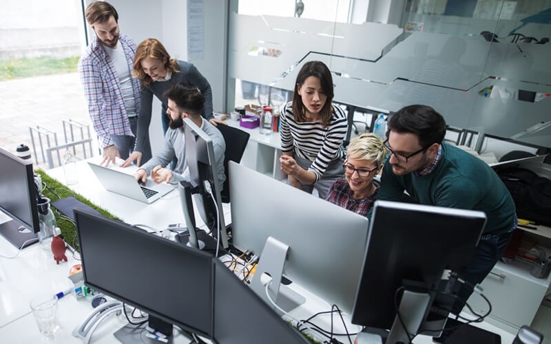 Group of business professionals in office monitoring customer interaction