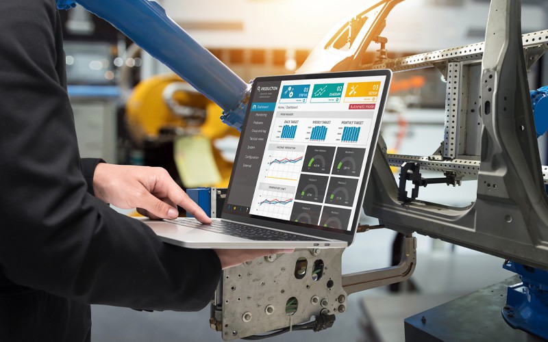 Close up of laptop using manufacturing software to interact with machine